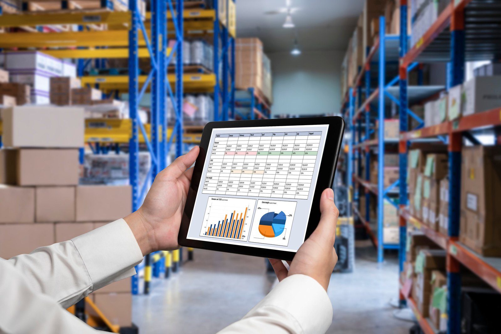 Inventory dashboard on a tablet in a warehouse aisle